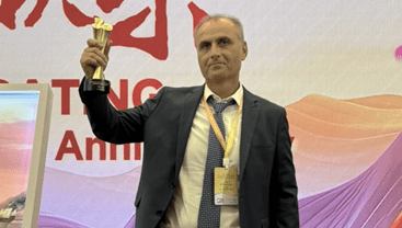 Ali E. Cevik gets an award in Beijing 2025.