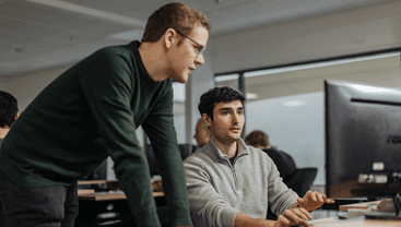 Two employees chatting at HR-ON.